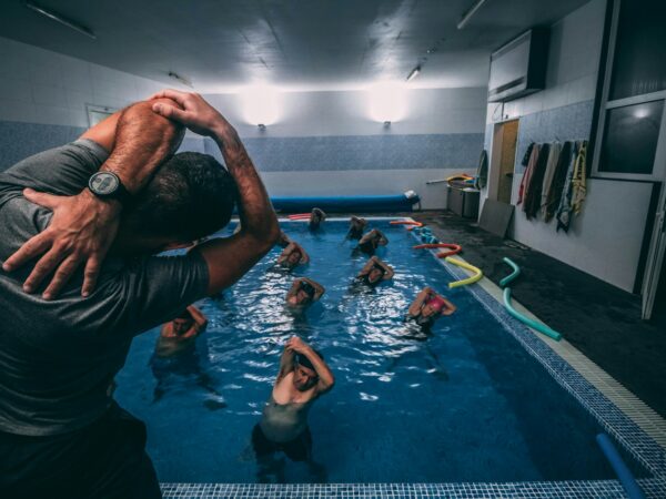 people stretching inside pool room